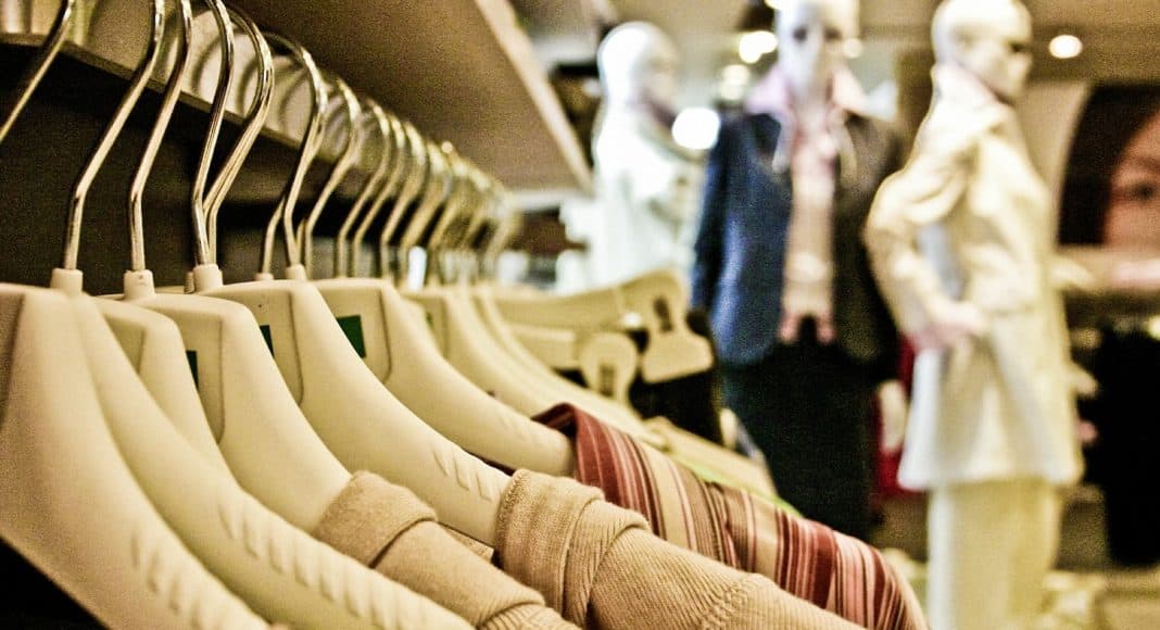 Kleider, welche im Laden hängen. Die Textilindustrie ist eine grosse Umweltbelastung.